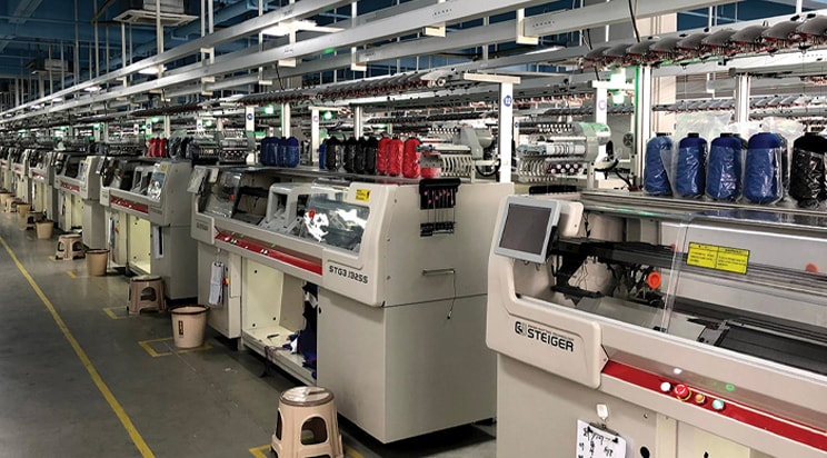 The featured image shows machines in a factory.